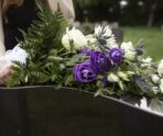 close up woman visiting grave loved one scaled e1719781092873 Стали известны причины смерти легендарного российского рок-музыканта