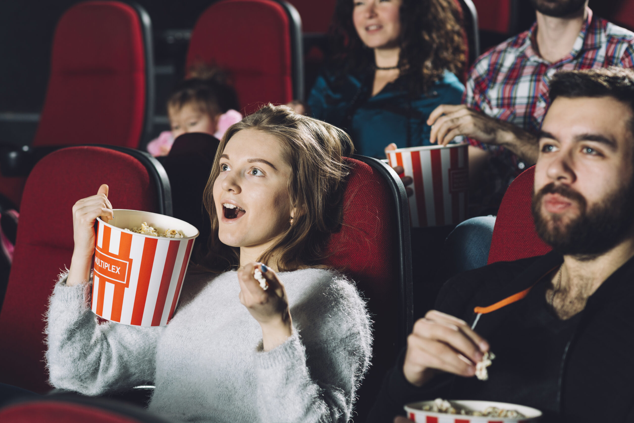 excited woman watching movie cinema scaled В Минкульте пояснили предложения о создании ремейков советских фильмов