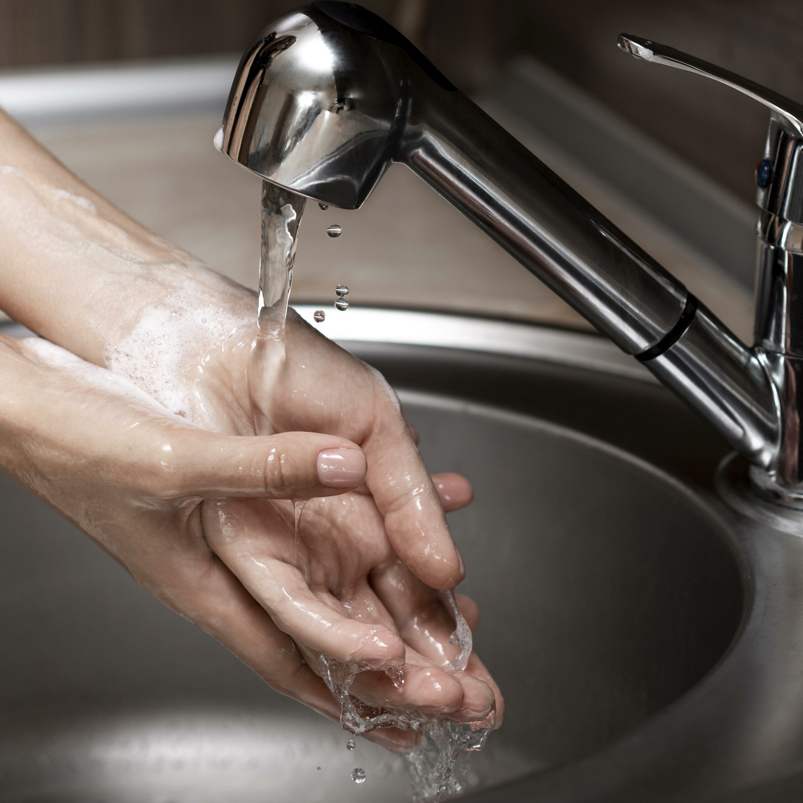 woman washing hands sink close up scaled Стало известно, почему на Химмаше снова отключили горячую воду