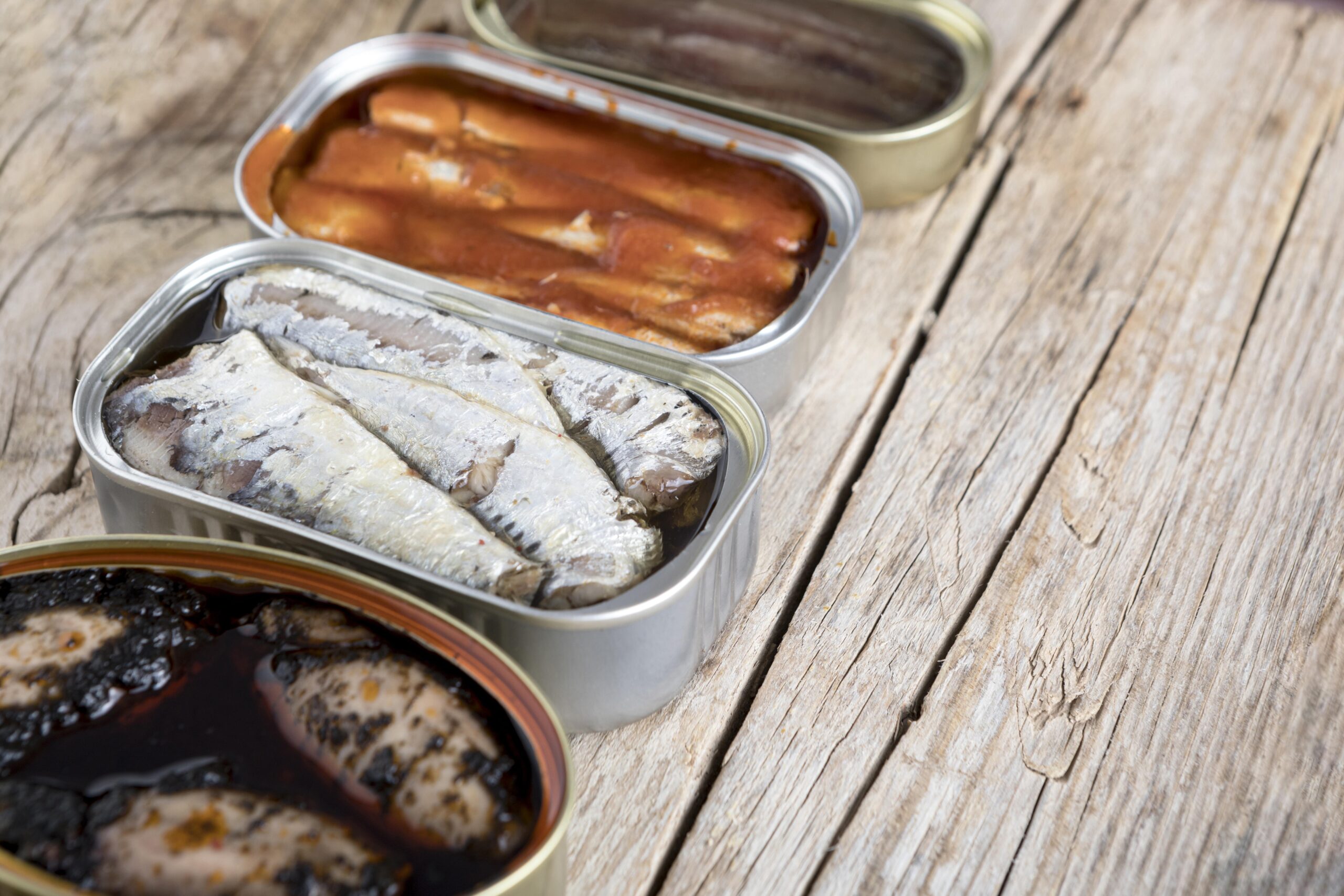 high angle cans with seafood scaled Роспотребнадзор объяснил наличие страшных личинок в рыбных консервах в магазинах Москвы  