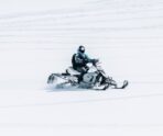 male riding snowmobile large snowy field «Жигули» завоевали командный кубок России по спидвею в Саранске